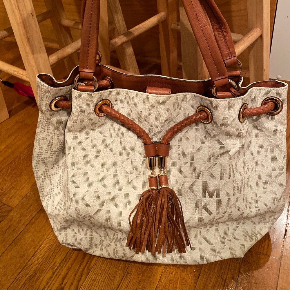 Michael Kors Logo White bag with leather tassel.